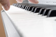 hand playing music on the piano
