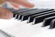 hand playing music on the piano