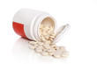 Close-up pill and bottle on white background