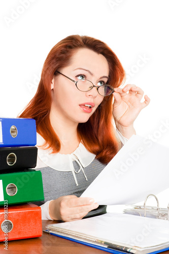 Photo: dreaming business woman in glasses looking at the paper dreaming business woman in glasses looking at the paper