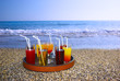 tray with drinks on the beach sand