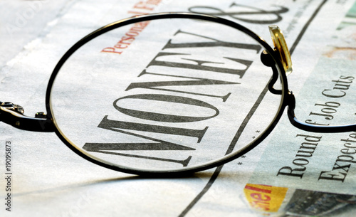 Photo: Focus on money investing on a newspaper Focus on money investing on a newspaper