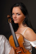 Young beautiful woman paying the violin