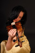 Young beautiful woman paying the violin