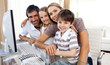 Portrait of a smiling family at a computer