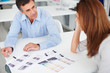 Mature business colleagues working together, focus on man