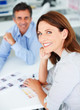 Mature business colleagues working together, focus on woman