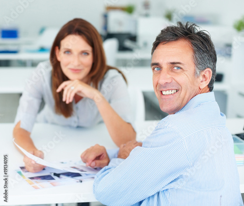 Photo: Happy successful business colleagues working together, focus on Happy successful business colleagues working together, focus on