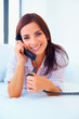Pretty female enjoying a conversation over the phone, on the cou