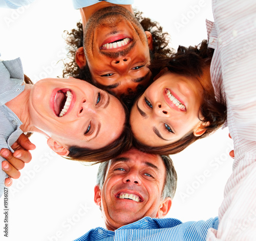 Photo: Upward view of business executives with their heads together Upward view of business executives with their heads together
