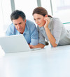 Senior mature couple working together on the computer
