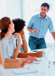 Boss giving presentation to his staff members
