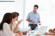 Successful business man giving presentation to his coworkers