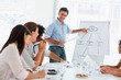 A business man giving a presentation using a flip chart