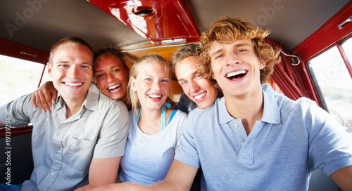Photo: Portrait of a group of friends inside a mini van heading to the Portrait of a group of friends inside a mini van heading to the