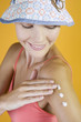 A Young Woman Rubbing Suntan Cream Into Her Arm
