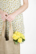 A Young Woman Carrying A Bunch Of Yellow Roses In A Shopping Bag