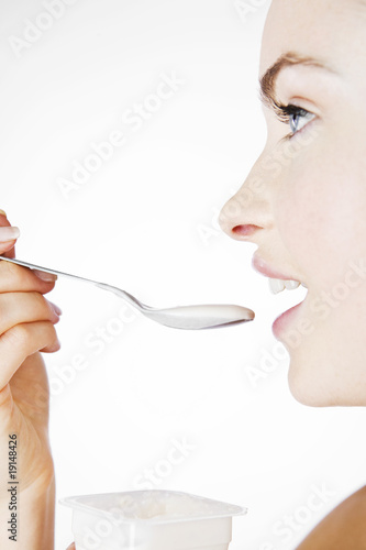 Photo: A Young Woman Eating A Yoghurt A Young Woman Eating A Yoghurt