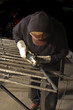 metal worker finishing welds with a grinder