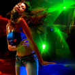 Beautiful young woman dancing in the nightclub