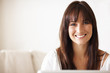 Portrait of a lovely female working on a laptop at home