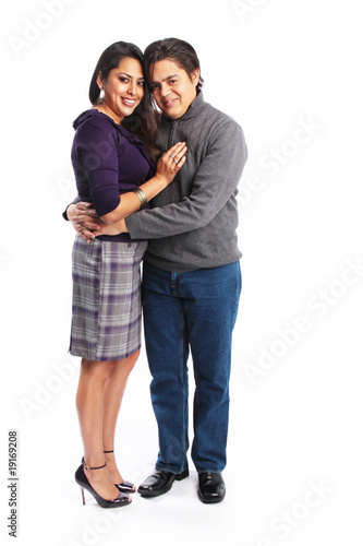 Photo: Full body picture of hispanic couple hugging isolated Full body picture of hispanic couple hugging isolated