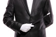 A magician in a suit holding a magic wand isolated on white A magician in a suit holding a magic wand isolated on white