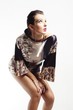 woman in satin tunic dress - looking at the light