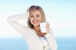Happy young female holding a cup of coffee , posing