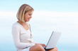 Happy female shopping online , blue sky as the background