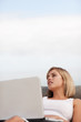 Cute young female using a laptop outside