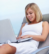 Happy young woman using a laptop to shop online , outdoors