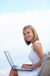 Beautiful female internet browsing on a laptop , outdoors