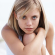 Cute relaxed female hugging her knee