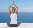 Rear view of a fit female practicing yoga while on a porch