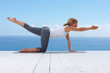 Fit woman doing stretches on a wooden porch