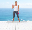 Cute young female working out with dumbbells on a porch