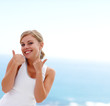 Pretty female showing the success sign , smiling outdoors
