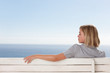 Young woman sitting isolated on a bench
