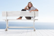 Pretty young female sitting isolated on a bench