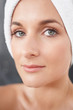Closeup portrait of a young woman with towel wrapped on head