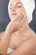Cute female relaxing at the bathroom , wrapped in a towel