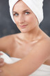 Happy young female wrapped in a towel