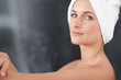 Happy sweet woman with a towel around head