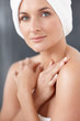Cute woman with a towel around head , hands crossed over chest