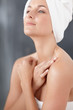 Cute woman wrapped in a towel , hands crossed over chest