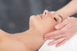 Young female getting a massage by a masseuse at the spa