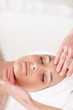 Top view of a young female getting a massage by a masseuse