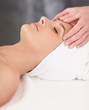 Pretty woman getting a massage by a masseuse at the spa