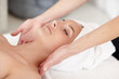 Young woman getting a massage by a masseuse at the spa